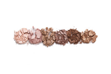Broken neutral toned eye shadow palette isolated on a white background