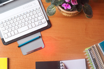 Office desk table with computer, supplies, flower. Copy space for text