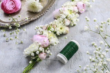 Florist at work. Steps of making wedding wreath