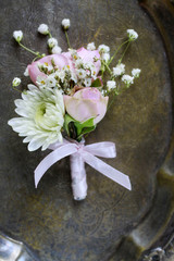 Florist at work. Steps of making wedding boutonniere