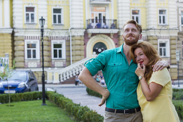 happy couple man and woman hugging in city