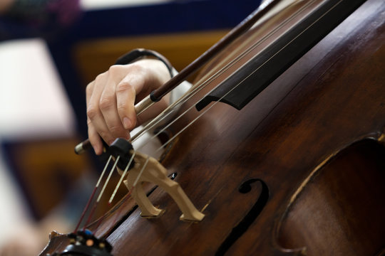 Hand girl playing cello closeup