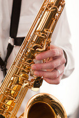Obraz premium Saxophone musician in his hands closeup