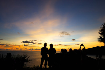 Fototapeta na wymiar travelers watching sunset at Promthep Cave, Phuket, Thailand