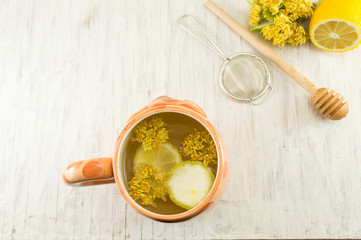 Tea of linden trees with fresh flowers and lemon
