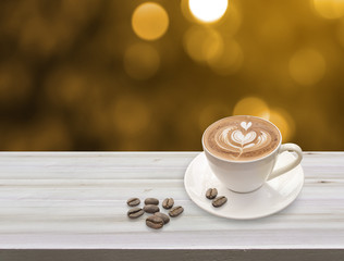 Obraz premium warm cup of coffee latte art with heart pattern in a white cup