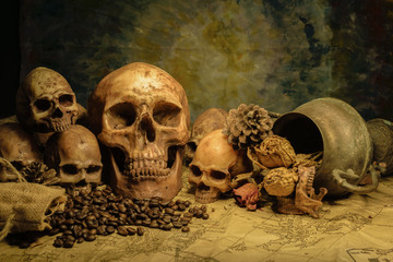 Adult human skull with  many small skulls, on the map still light human skulls, classic skulls background