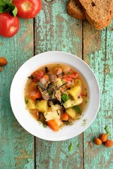 Homemade chorba soup with lamb meat on bone, potato, carrots