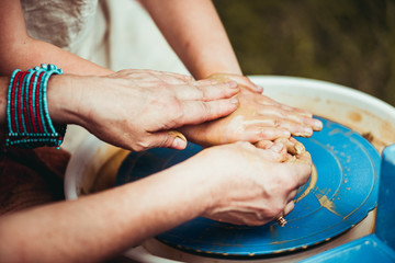 child working on potter's wheel