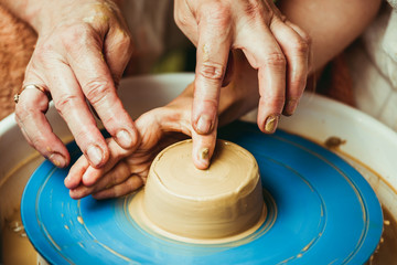 child working on potter's wheel