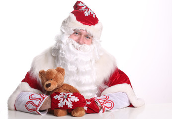 Portrait smiling Father Frost holding a teddy bear