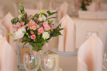 flower composition and candles in the restaurant. Wedding dinner