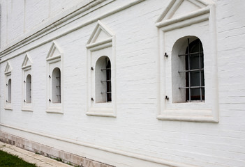 Fototapeta na wymiar Barred windows in white brick wall