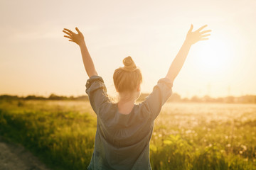 female teen girl stand feel freedom with arms stretched to the sky - obrazy, fototapety, plakaty