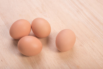 Fresh eggs ingredient on a wooden table rustic background.