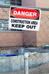 Danger construction area keep out sign in front of foundation addition