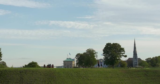 Men And Women Jogging In The Green City Park Of Copenhagen. Sport Training To Keep Fit