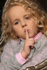 Naklejka premium Portrait of little blond girl, like doll with curly hair