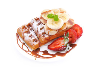 Breakfast.Waffles with banana slices and strawberries.