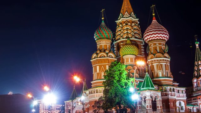Time-lapse. Saint Basil Cathedral on Red Square at night with Kremlin Tower, Moscow. One of the most popular landmark in Russia. The building is shaped as a flame of a bonfire rising into the sky