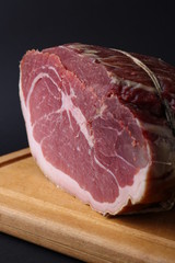 Piece of fresh red meat on wooden board. Close up