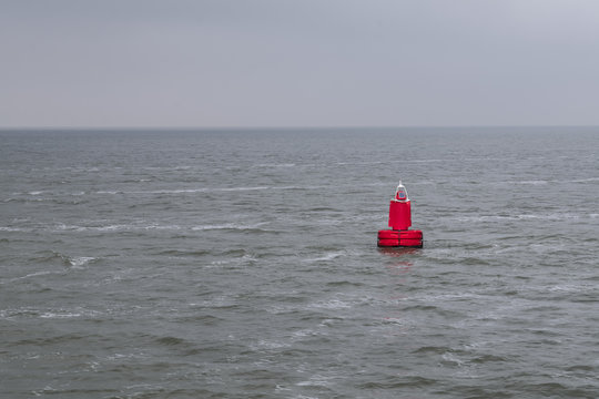 Red bouy floating in sea