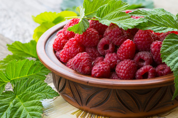 Fresh ripe raspberries on the wooden table