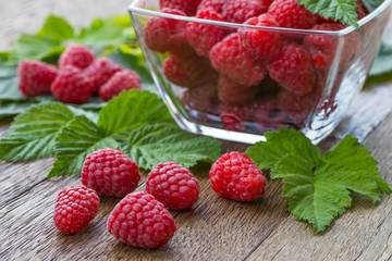 Fresh ripe raspberries on the wooden table