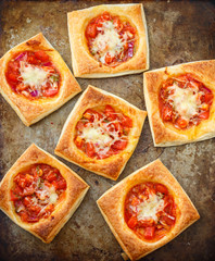 Puff pies with tomato, red onion and cheese