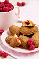 French pastry Madeleine with raspberries.