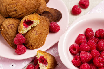 French pastry Madeleine with raspberries.
