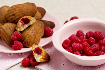 French pastry Madeleine with raspberries.