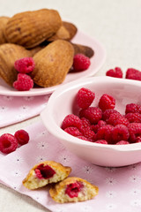 French pastry Madeleine with raspberries.
