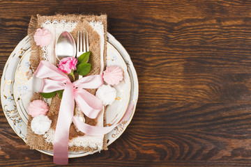 Tableware with light pink roses and meringues