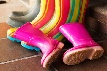 Colourful wellington boots left on a doorstep