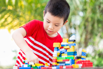 Asian boy build plastic block