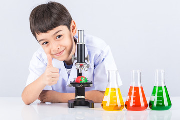 Little scientist boy with colorful flask