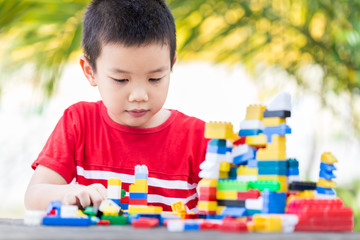 Asian boy build plastic block