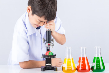 Little scientist boy with colorful flask