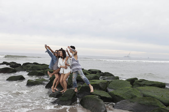 Friends posing for a selfie on the beach