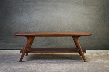 Coffee table on concrete floor against concrete wall