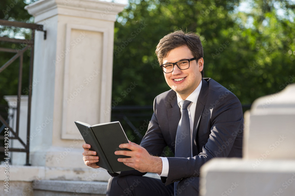 Sticker Smiling businessman with book