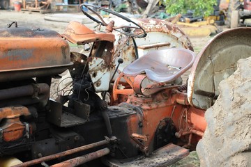 An old and dirty tractor that is abandoned