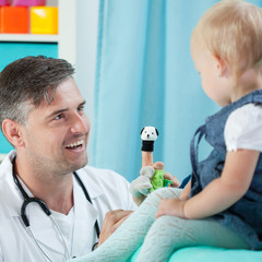 Fototapeta premium Smiling pediatrician and his little patient