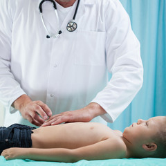 Pediatrician doing abdominal examination