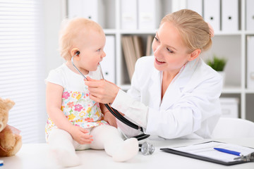 Fototapeta premium Happy cute baby after health exam at doctor's office