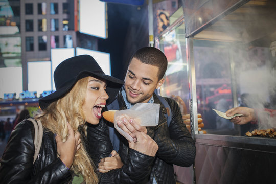 Young couple eating street food