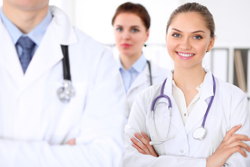 Fototapeta premium Happy doctor woman with medical staff at the hospital