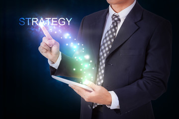 Businessman holding tablet with pressing strategy. internet and networking concept