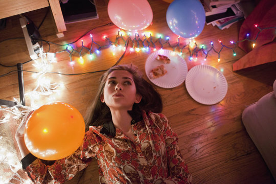 Young women illuminated by string lights